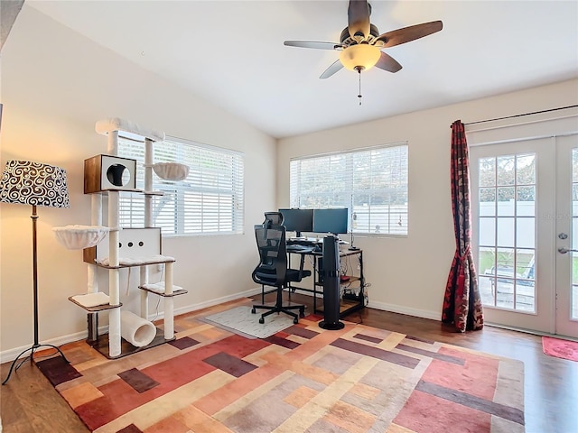 home office with french doors, a healthy amount of sunlight, light hardwood / wood-style floors, and lofted ceiling