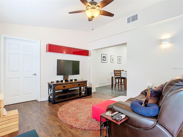 living room featuring ceiling fan, dark wood-type flooring, and lofted ceiling