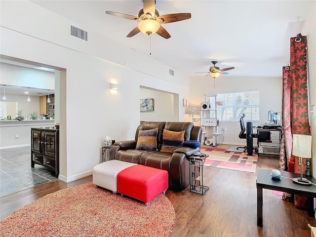 living room with hardwood / wood-style flooring, ceiling fan, and lofted ceiling