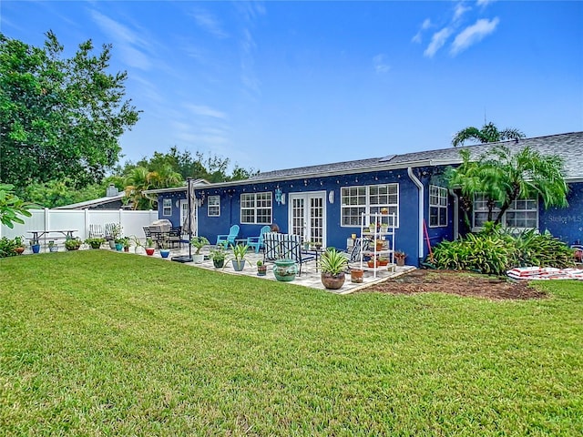 back of property featuring a lawn, french doors, and a patio