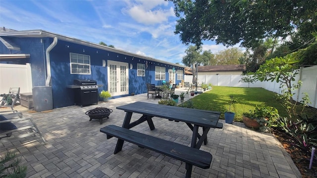 view of patio / terrace featuring french doors, area for grilling, and a fire pit