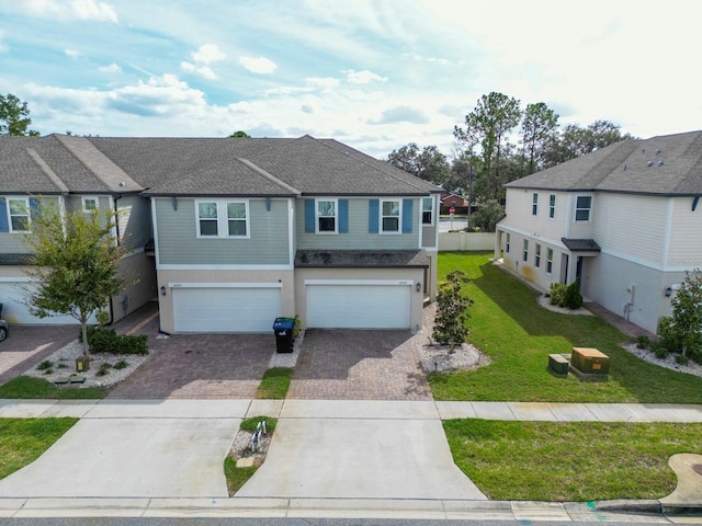 view of front of home with a garage and a front yard