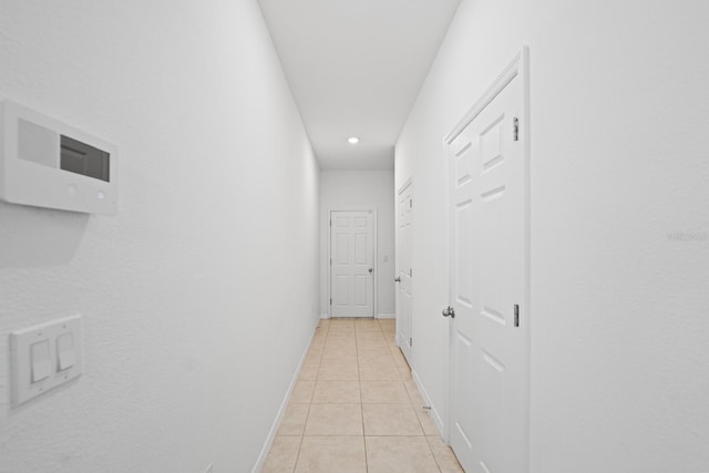 corridor featuring light tile patterned floors