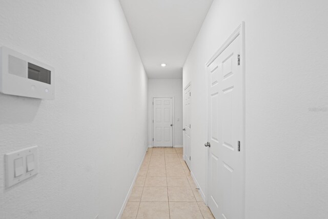 15109 Willow Arbor Cir, Orlando, FL 32824 - corridor featuring light tile patterned floors, recessed lighting, and baseboards