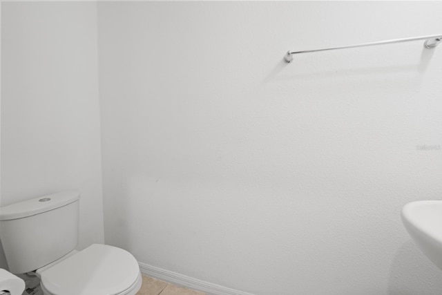 bathroom with tile patterned flooring and toilet