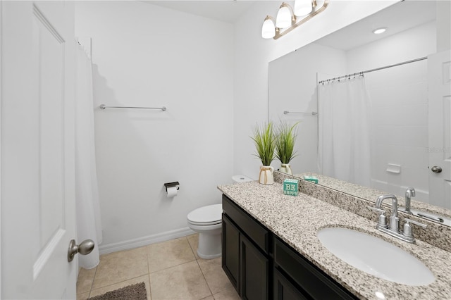 bathroom featuring toilet, vanity, tile patterned floors, and curtained shower