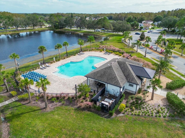 view of swimming pool featuring a patio and a water view