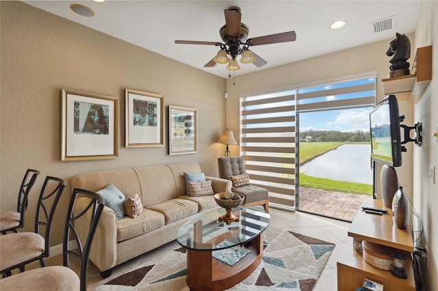 living room featuring light tile patterned floors and ceiling fan