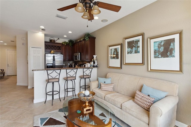 living room featuring ceiling fan and light tile patterned floors