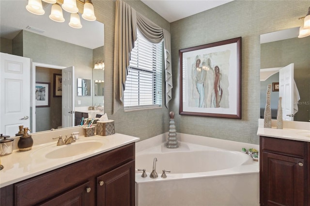 bathroom featuring a bath and vanity