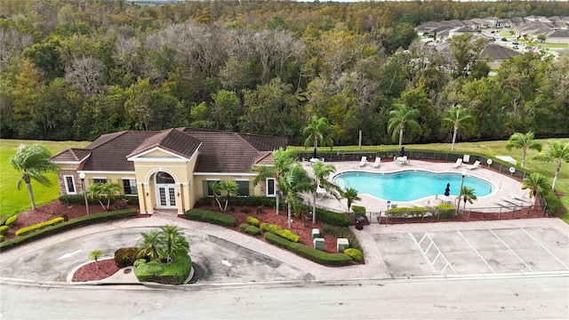 view of pool with french doors and a patio area