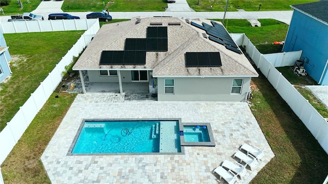 back of house with a fenced in pool, a yard, solar panels, and a patio area