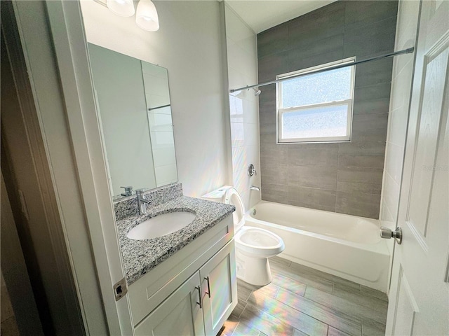 full bathroom with toilet, tiled shower / bath combo, vanity, and wood-type flooring