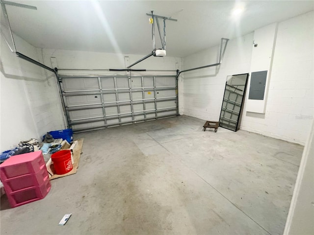 garage with electric panel and a garage door opener