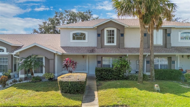 1220 Garden Isle Ct, Orlando, FL 32824 - view of front facade with stucco siding, a front yard, and roof with shingles