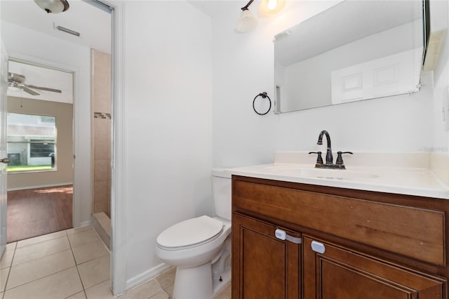 1220 Garden Isle Ct, Orlando, FL 32824 - full bathroom featuring toilet, vanity, ceiling fan, tile patterned flooring, and walk in shower