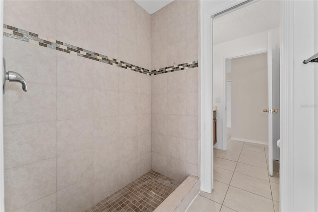 bathroom with tile patterned floors and tiled shower