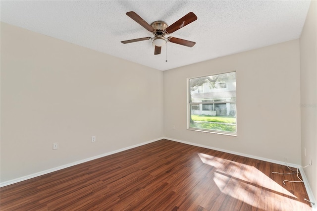 unfurnished room with a textured ceiling, dark hardwood / wood-style floors, and ceiling fan