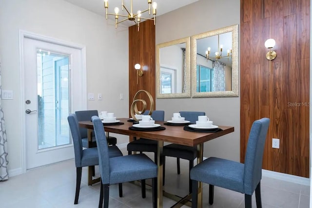 tiled dining space with plenty of natural light and a notable chandelier