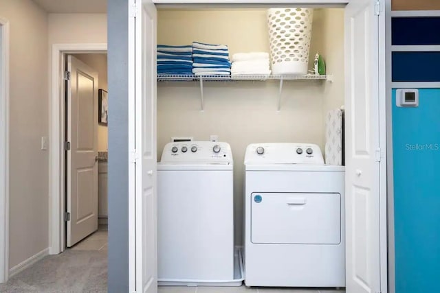 clothes washing area with washer and dryer