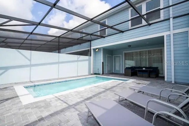 view of swimming pool featuring a lanai and a patio