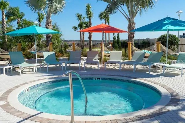 view of pool featuring a community hot tub and a patio