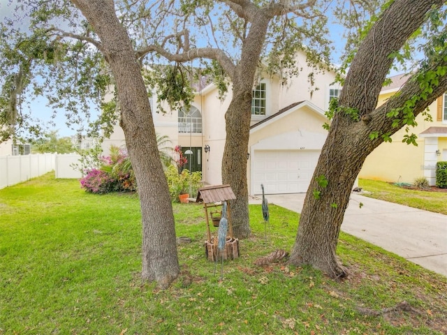 view of front of property with a front lawn and a garage