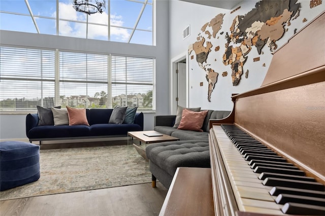 living room with hardwood / wood-style flooring and a high ceiling