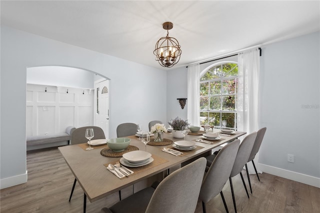 dining room featuring hardwood / wood-style floors and a notable chandelier