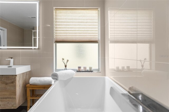 632 Pinewood Dr, Davenport, FL 33896 - bathroom featuring tile walls and vanity