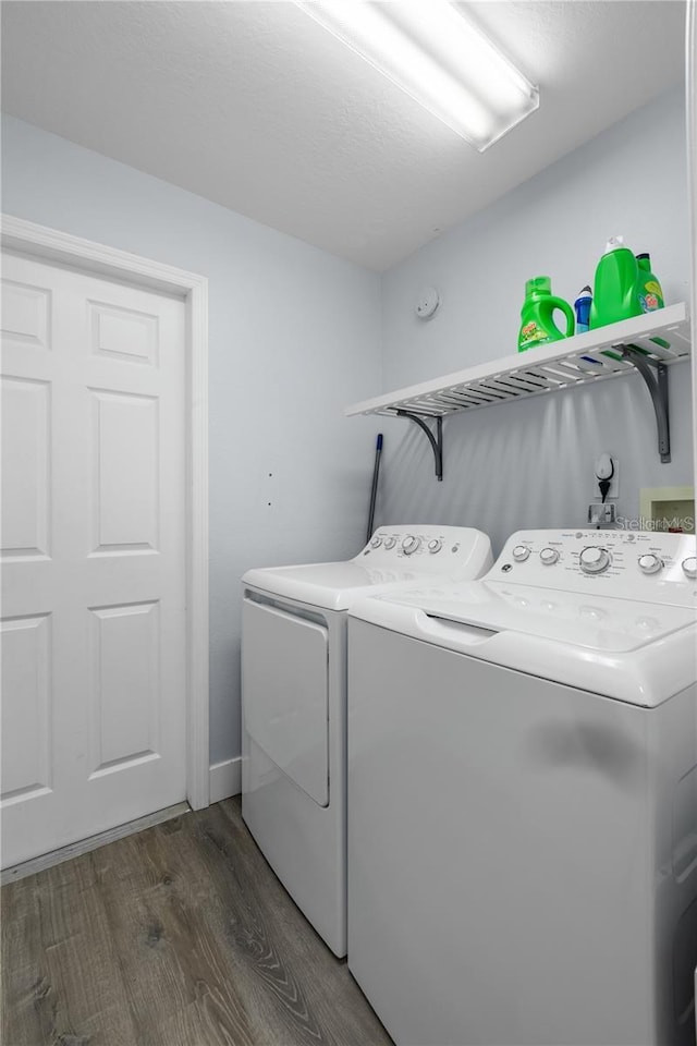 laundry room featuring washer and dryer and dark hardwood / wood-style flooring