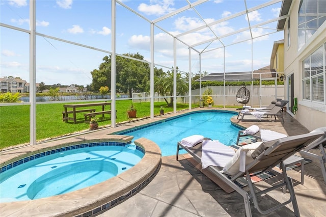 view of swimming pool with a lanai, a lawn, an in ground hot tub, and a patio area