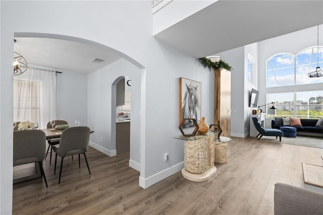 interior space featuring wood-type flooring and a chandelier