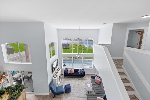 living room featuring light wood-type flooring and a chandelier