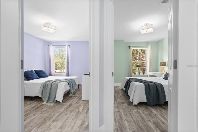 632 Pinewood Dr, Davenport, FL 33896 - bedroom featuring light wood finished floors, multiple windows, and baseboards