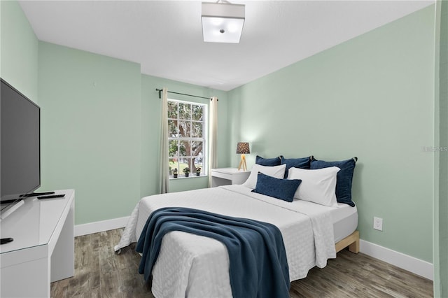 bedroom with hardwood / wood-style floors