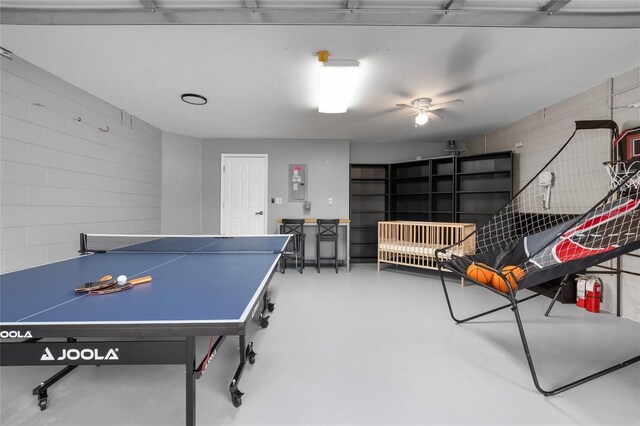 632 Pinewood Dr, Davenport, FL 33896 - playroom with concrete floors, concrete block wall, and ceiling fan
