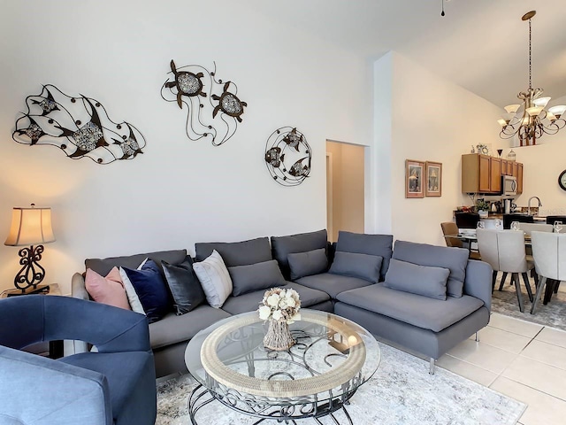 tiled living room with high vaulted ceiling and a chandelier