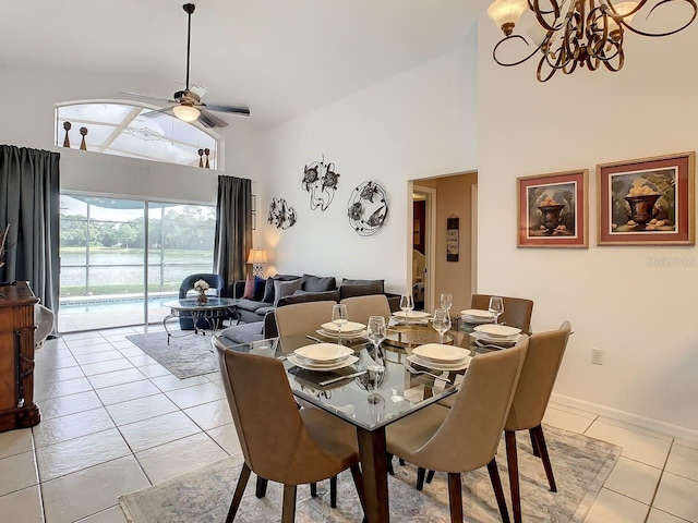 tiled dining room featuring ceiling fan and high vaulted ceiling