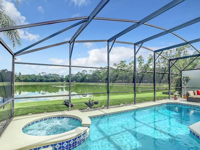 view of pool with an in ground hot tub, a yard, a water view, and glass enclosure