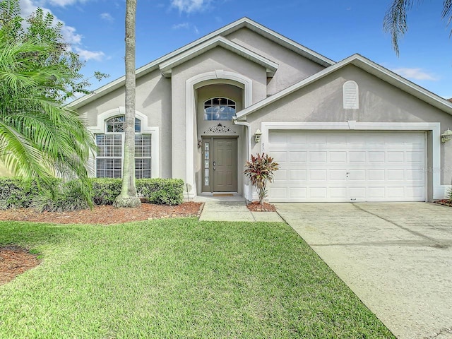 view of front of property featuring a front yard and a garage