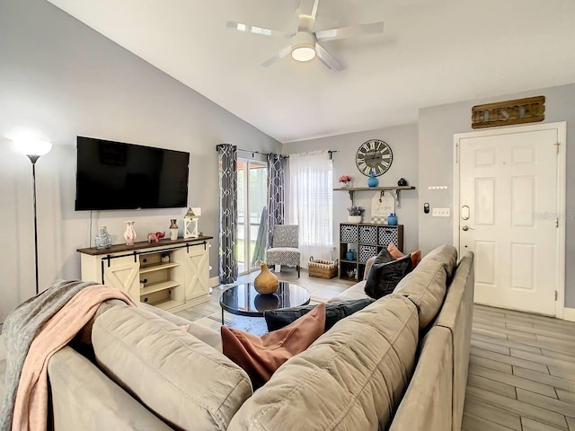 living room featuring light wood-type flooring, lofted ceiling, and ceiling fan