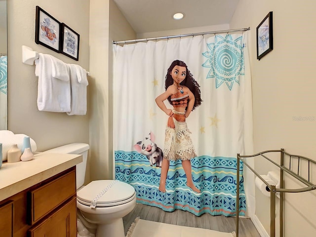 bathroom featuring vanity, hardwood / wood-style flooring, toilet, and a shower with curtain