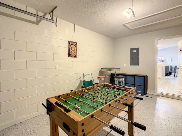 game room featuring electric panel and a textured ceiling