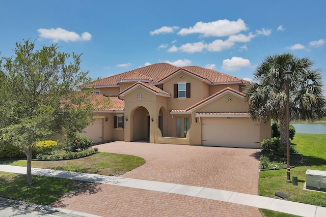 mediterranean / spanish-style house with a front yard