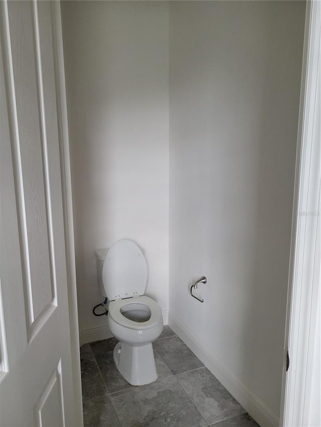 bathroom featuring tile patterned flooring and toilet