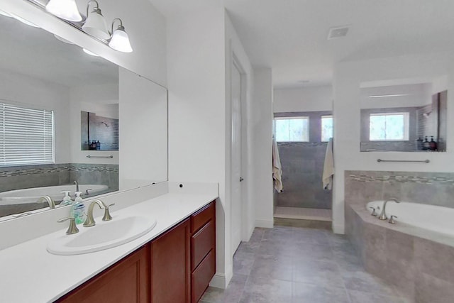 bathroom featuring vanity, tile patterned flooring, and separate shower and tub