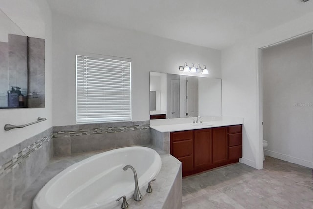 bathroom featuring a relaxing tiled tub, vanity, and toilet