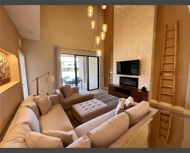 living room featuring a high ceiling and a fireplace