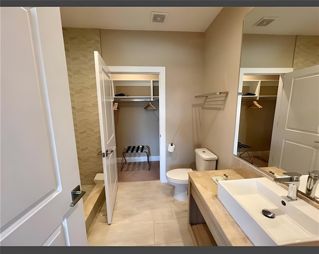 bathroom with vanity, toilet, and tile patterned flooring